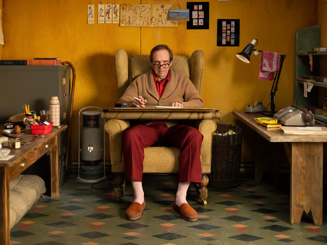 Henry Sugar production still with Henry Sugar seated at a desk